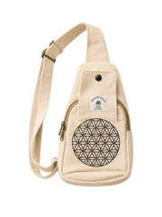 A beige canvas sling bag with a black geometric flower of life design on the front pocket, a white brand label reading 'Green Trees by the Park', and a black snap button. The bag is shown against a solid off-white background.