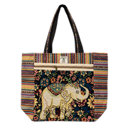 A large tote bag featuring a colorful bohemian design with a central elephant motif, striped borders, and black shoulder straps, shown against a plain white background.