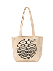 A beige canvas tote bag with a black geometric flower-of-life style circle printed on the front, featuring dual shoulder straps and a small sewn label on the upper right side, shown against a plain off-white background.