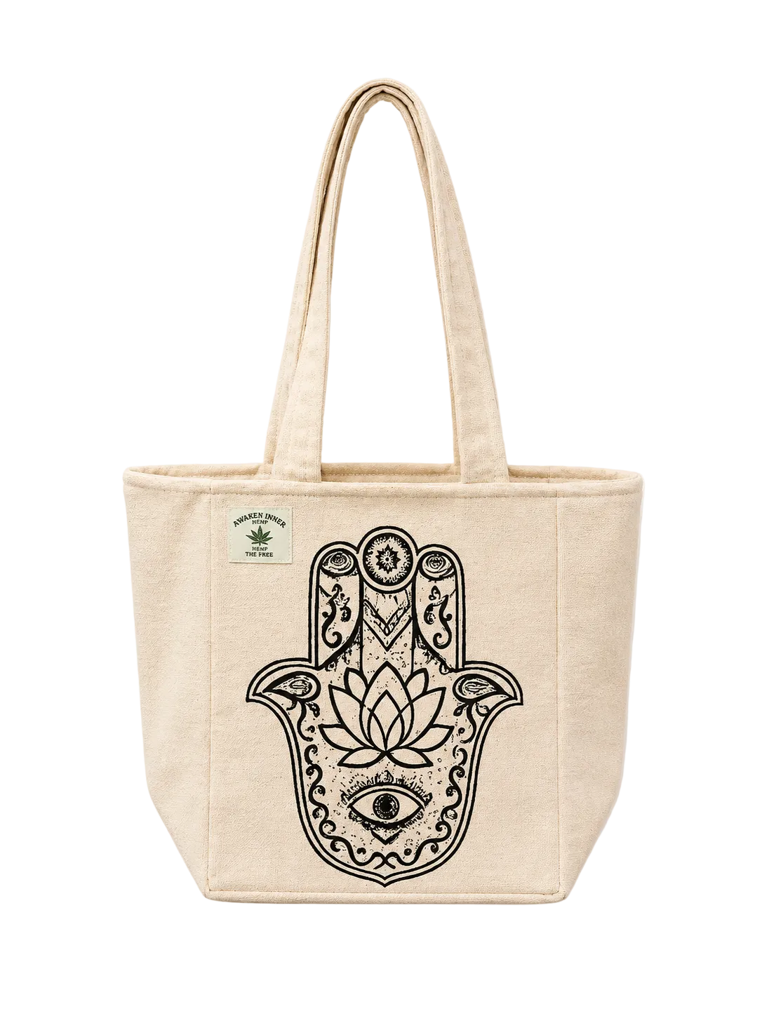 A natural beige canvas tote bag with a large black Hamsa hand graphic featuring a lotus flower and eye design on the front. A small green brand label is visible on the upper left side.