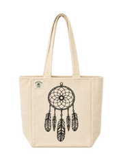 A natural canvas tote bag with a black dreamcatcher graphic printed on the front, featuring dual top handles and a small green brand patch on the upper left side.