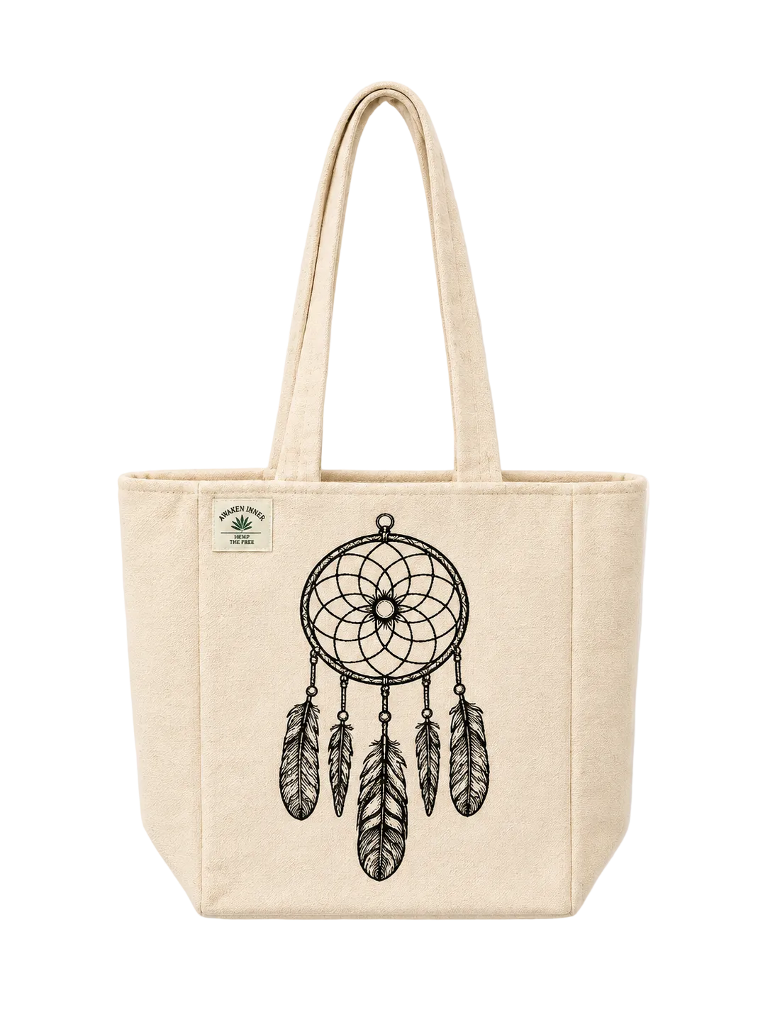 A natural canvas tote bag with a black dreamcatcher graphic printed on the front, featuring dual top handles and a small green brand patch on the upper left side.