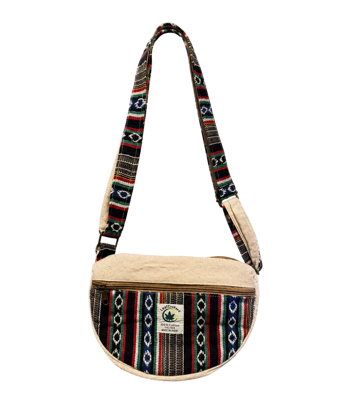 A small crescent-shaped shoulder bag with a beige fleece lining and a colorful woven patterned strap and front panel. A small white label on the front reads 'SACRED CANNABIS CLOTHING'.